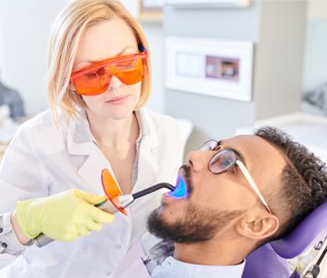 Man having laser dental procedure from a dentist